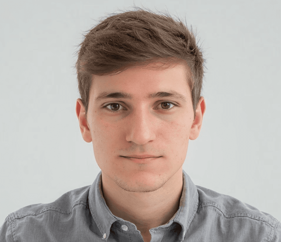 Professional headshot of Ryan Yannelli, CTO and co-founder of Nextvisit, Inc., wearing a button-down shirt and looking at the camera.